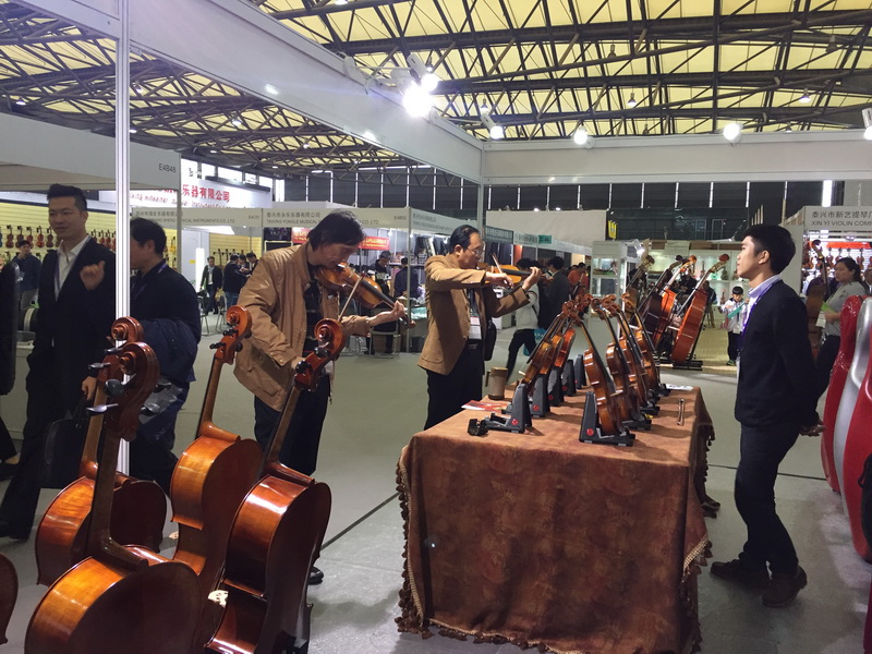 Visitors at the Lien Violins booth during Music China 2016