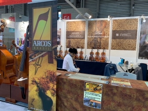 Visitors viewing instruments at the Lien Violins booth during Music China 2019