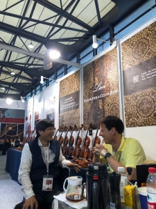 Visitors trying instruments at the Lien Violins booth in Shanghai
